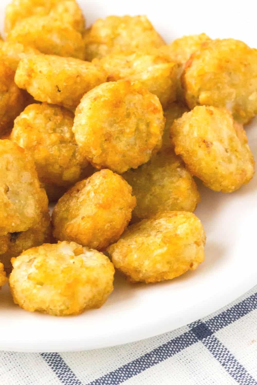 several Ore-Ida Crispy Crowns mini tater tots served on a white plate