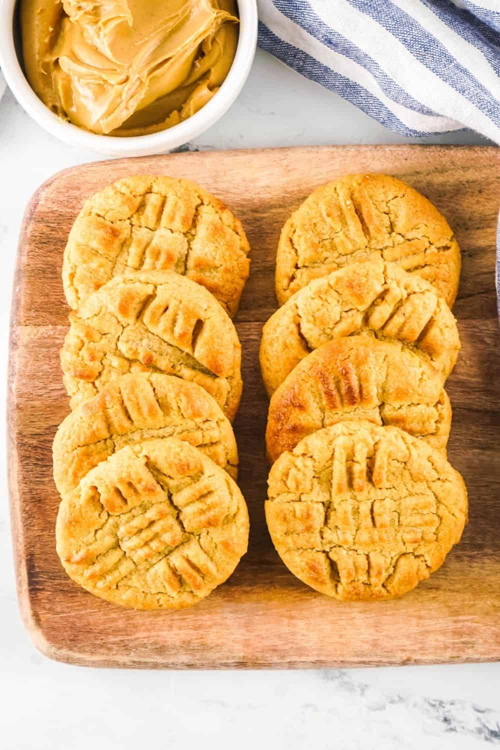 eight air fryer peanut butter cookies served on a wooden cutting board