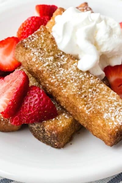 air fryer frozen french toast sticks topped with strawberries and whipped cream