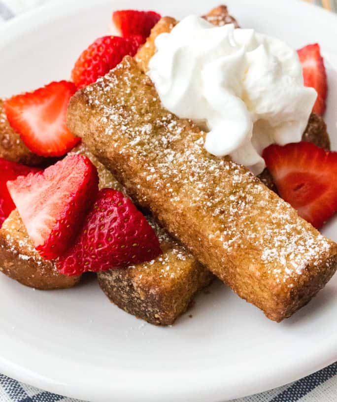 air fryer frozen french toast sticks topped with strawberries and whipped cream