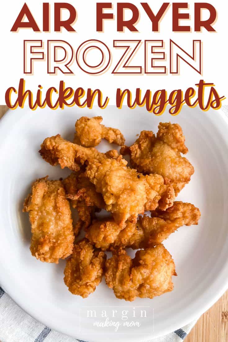 white plate with a serving of air fryer frozen chicken nuggets on it.