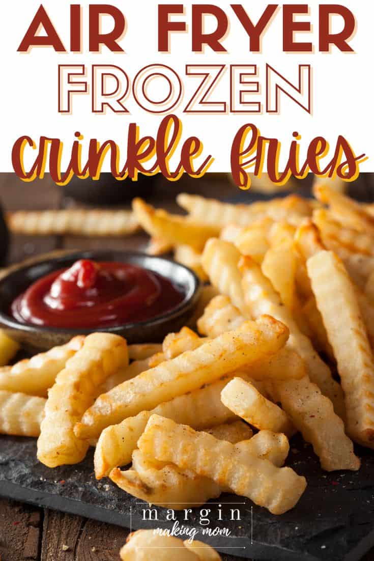 freshly cooked air fryer frozen crinkle fries served alongside a dish of ketchup