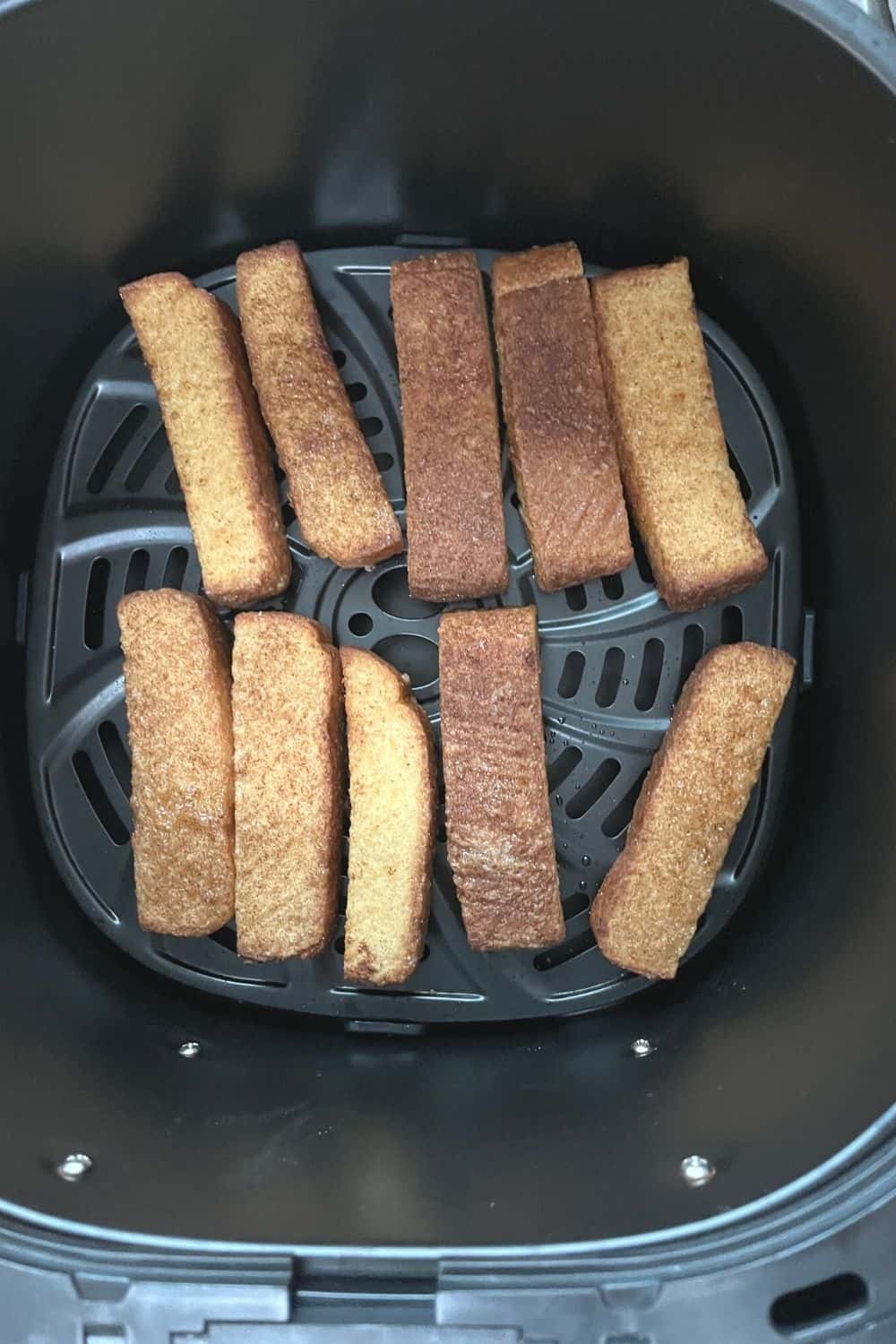 freshly baked air fryer frozen french toast sticks still in the air fryer basket