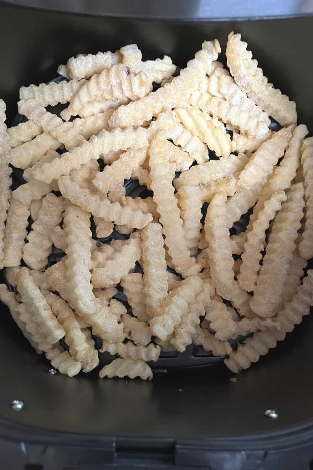 frozen ore-ida crinkle fries in an air fryer basket