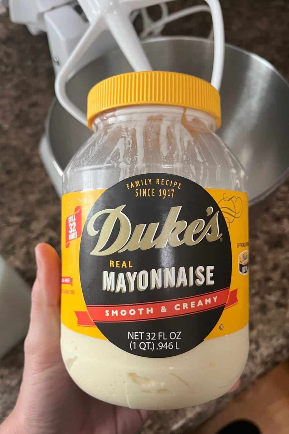 woman's hand holding a jar of Duke's real mayonnaise
