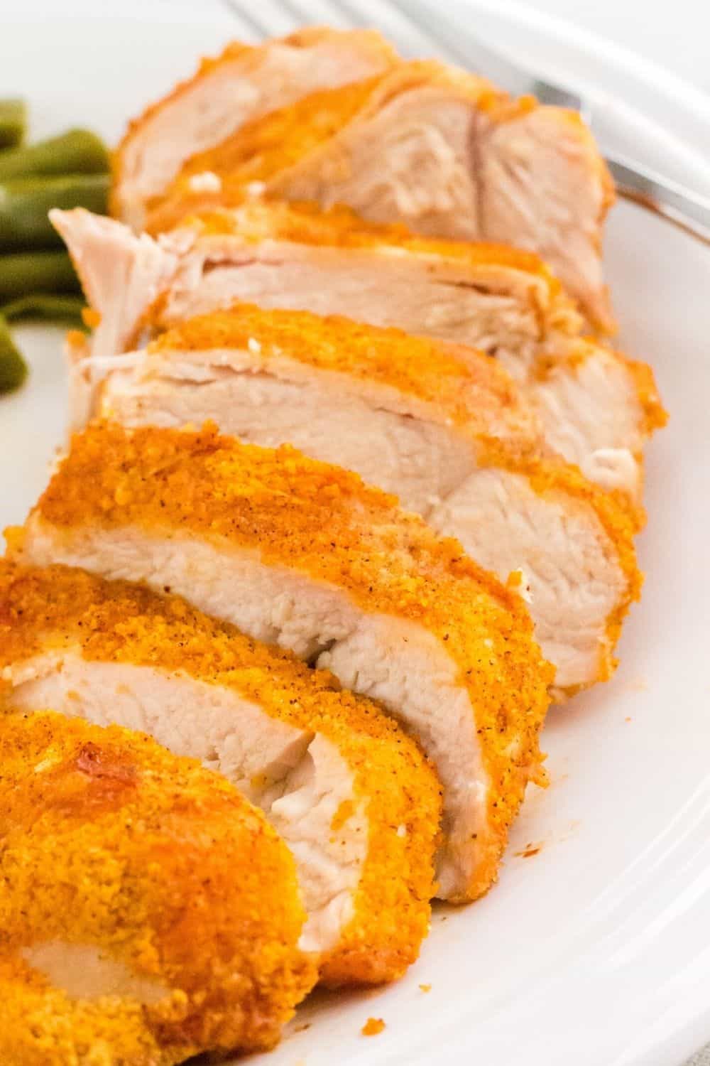 close-up view of a sliced shake n bake chicken breast cooked in the air fryer