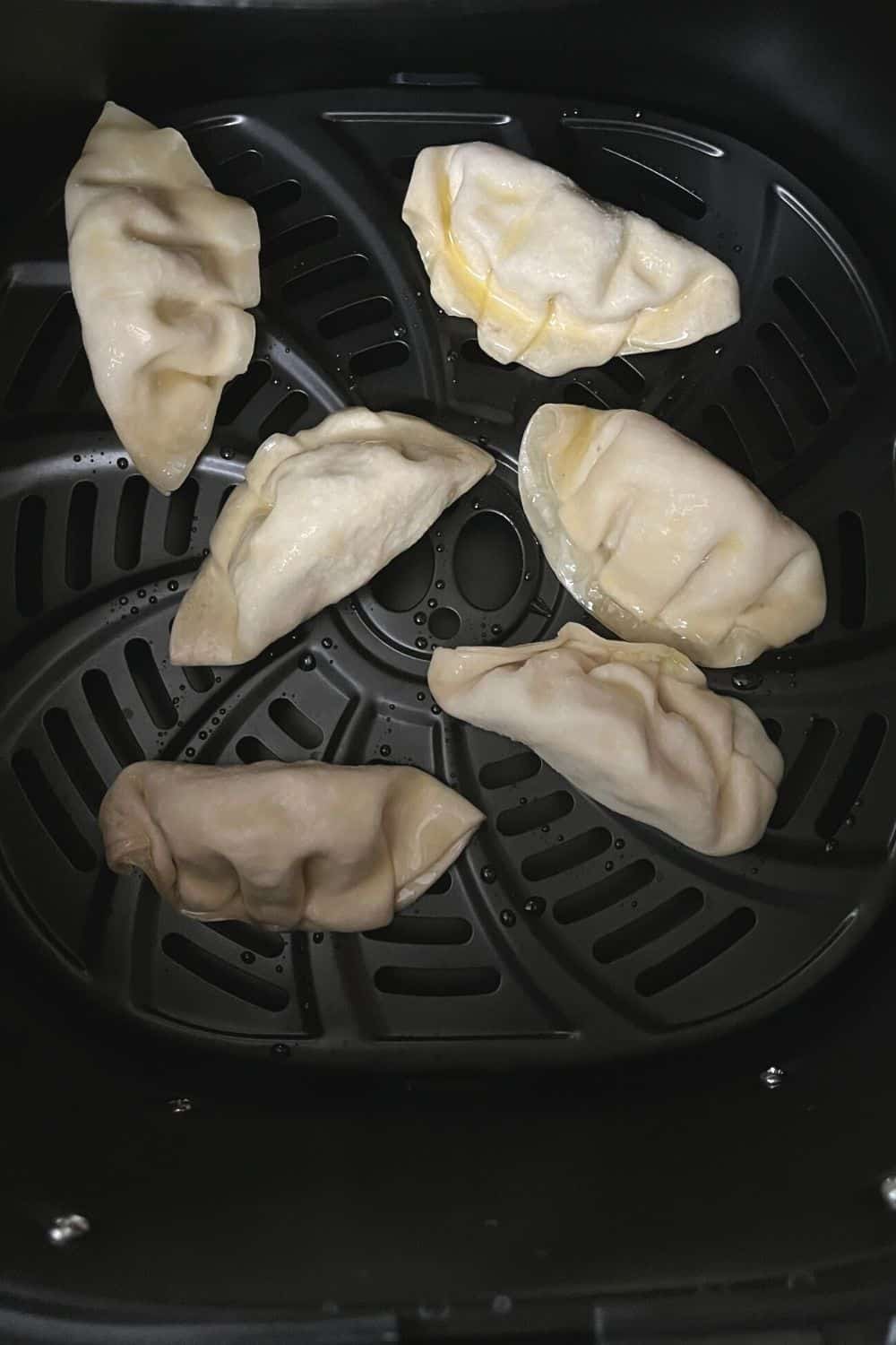 frozen dumplings in the basket of an air fryer