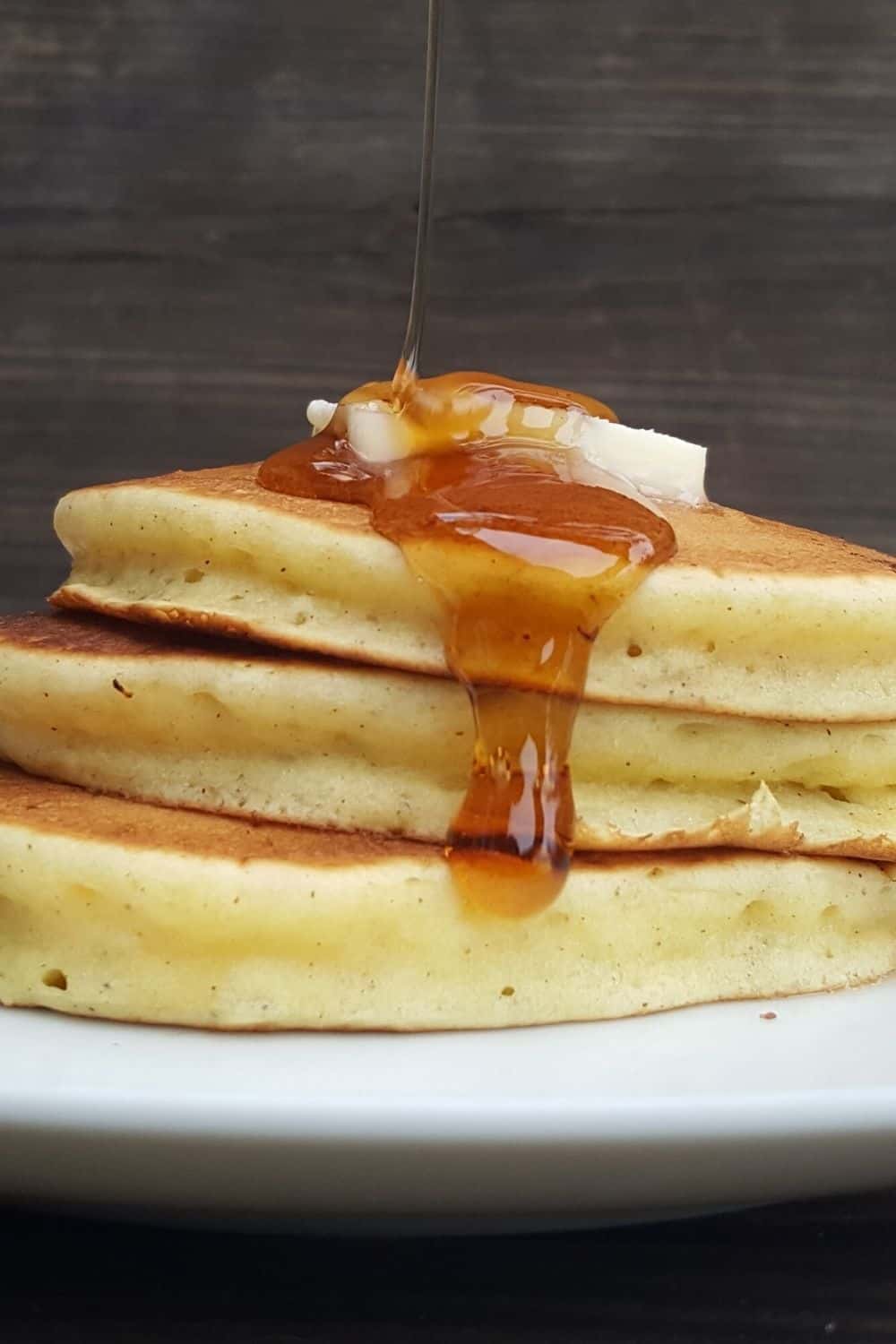 a stack of pancakes made without baking powder is topped with butter and syrup