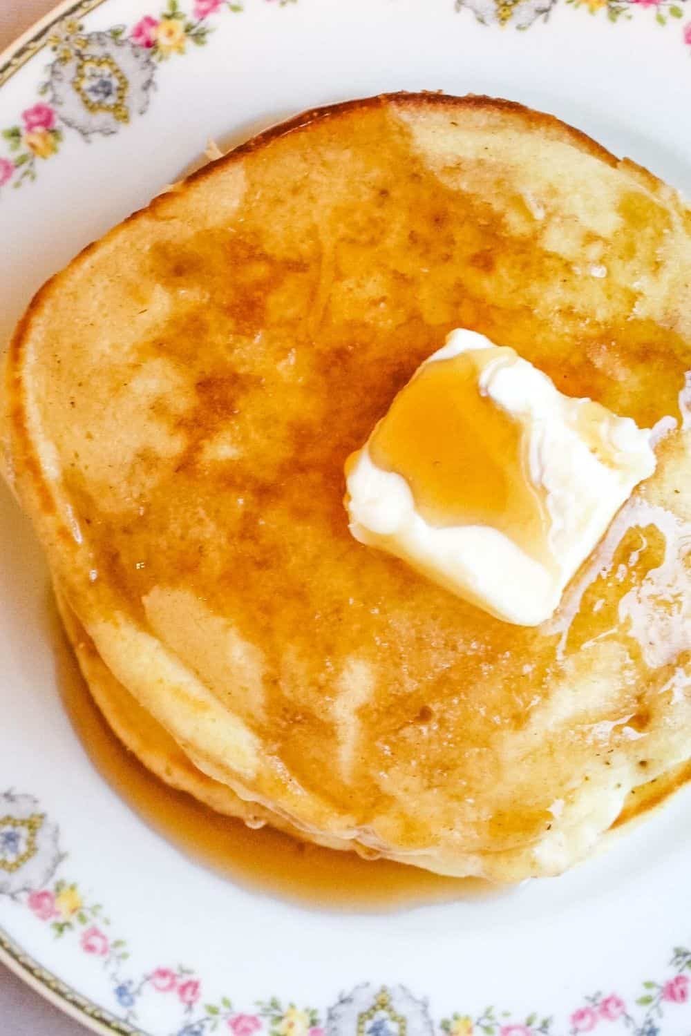 a stack of pancakes made without baking powder, topped with butter and syrup