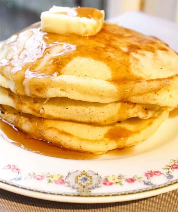 stack of pancakes made with self-rising flour, topped with butter and syrup