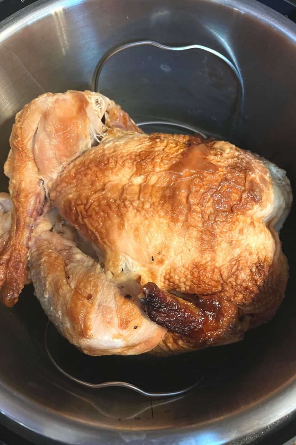 cold rotisserie chicken placed on a trivet in the instant pot