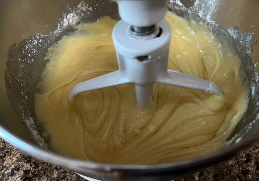 mixed cake batter in a mixing bowl for making a vanilla bundt cake