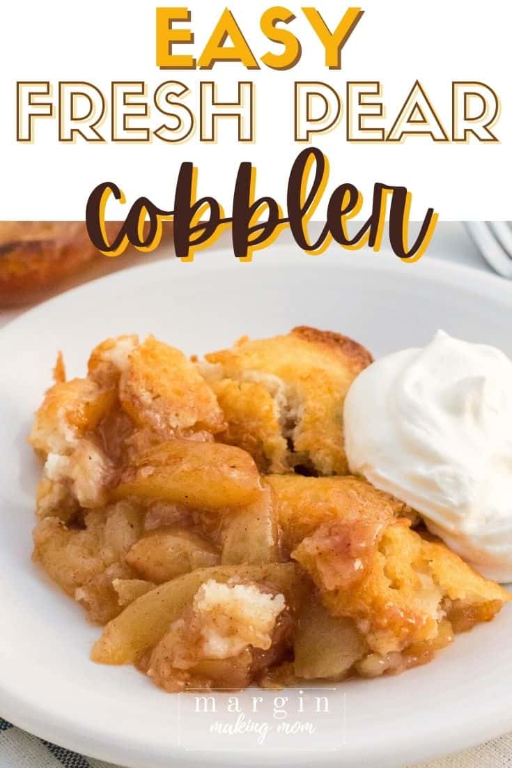 pear cobbler made with fresh pears is served on a white plate with a dollop of whipped cream