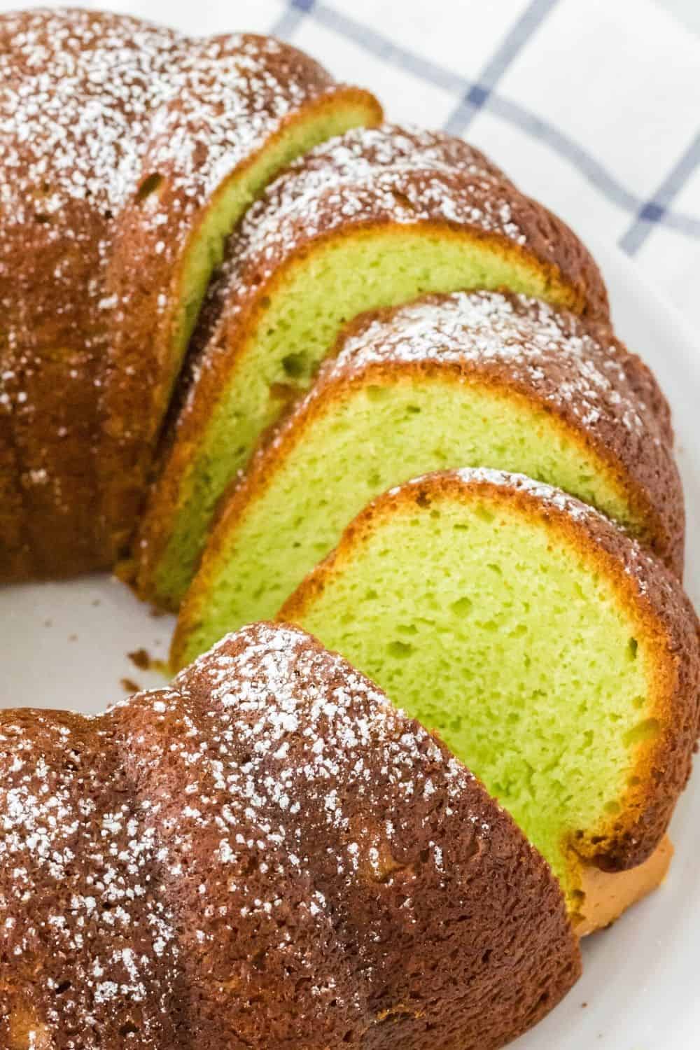 three slices of easy pistachio cake made from a mix and dusted with powdered sugar