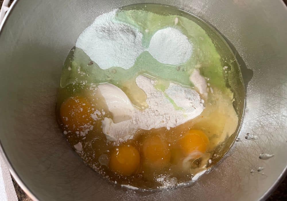 cake mix, pudding mix, eggs, sour cream, and oil added to a mixing bowl