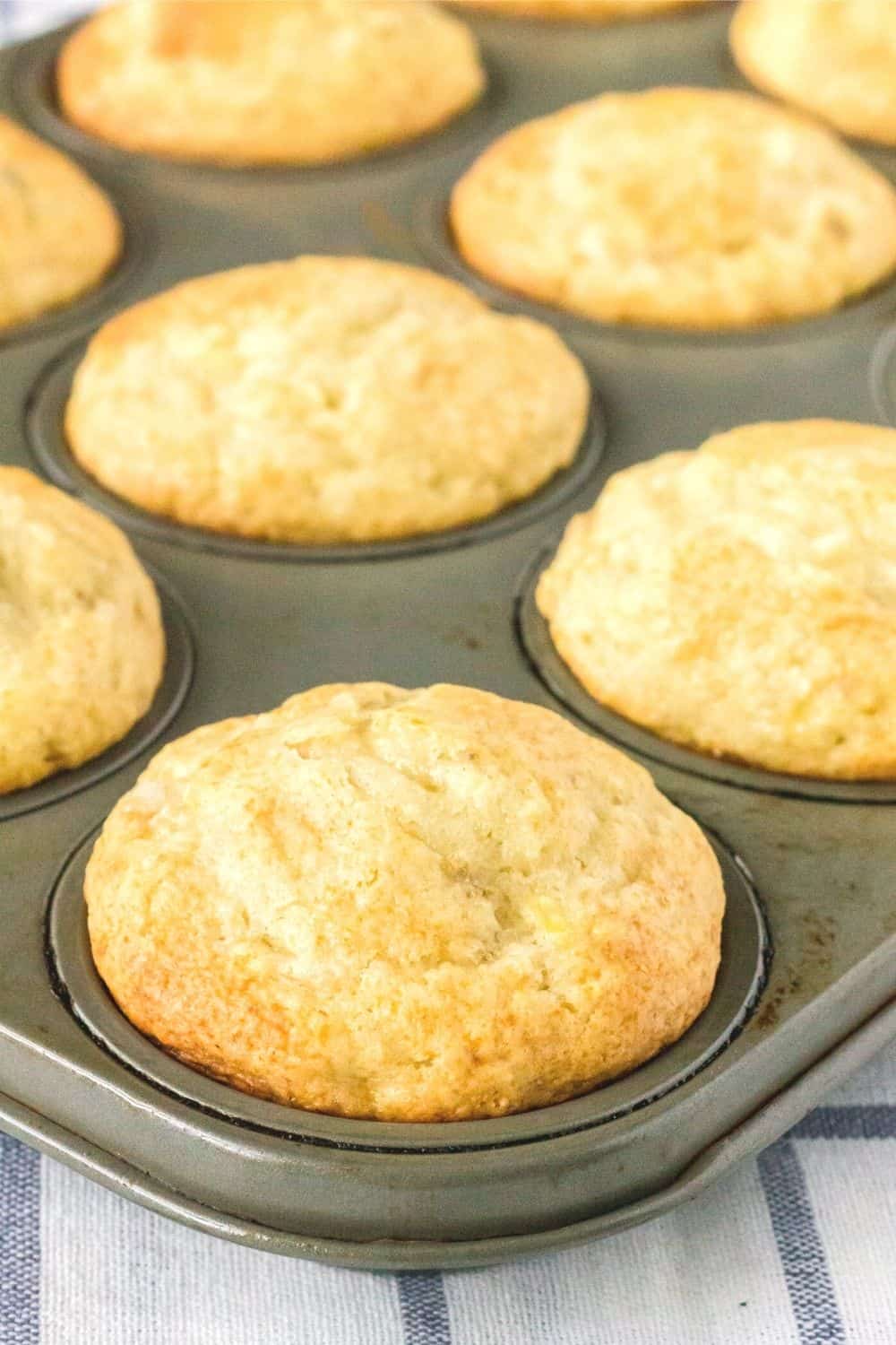 a muffin pan with bisquick banana muffins in it.