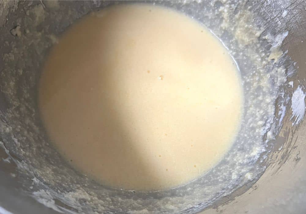 milk added to the muffin mixture in a mixing bowl.