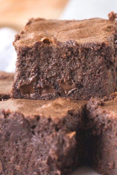 a trio of condensed milk brownies, cut into squares and stacked together.