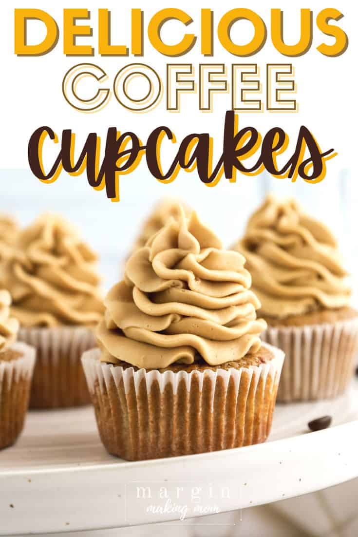coffee cupcakes topped with coffee frosting displayed on a cake stand