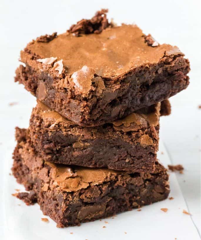 three triple chocolate brownies stacked on top of each other