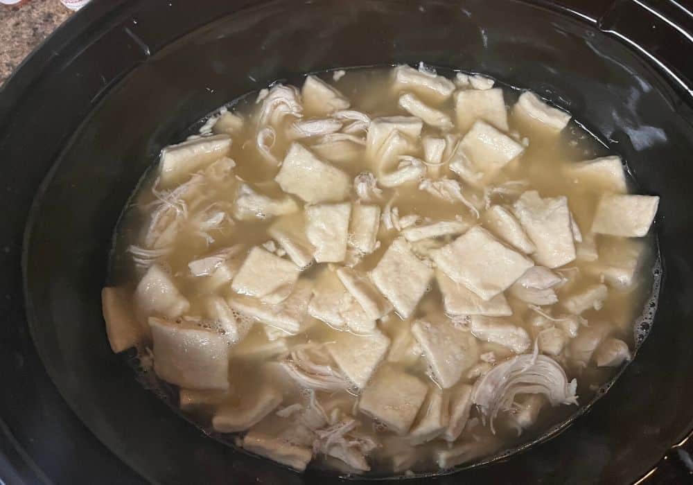 dumpling dough added to chicken and broth in the Crock Pot