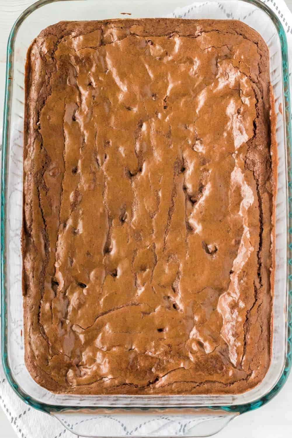 overhead view of a glass pan of brownies made with three types of chocolate