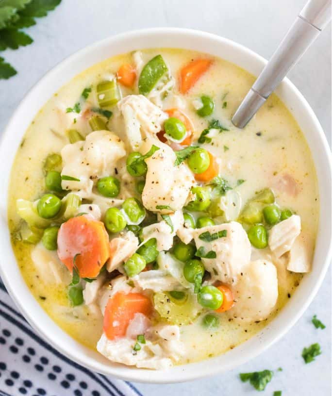 chicken and dumplings soup in a white bowl