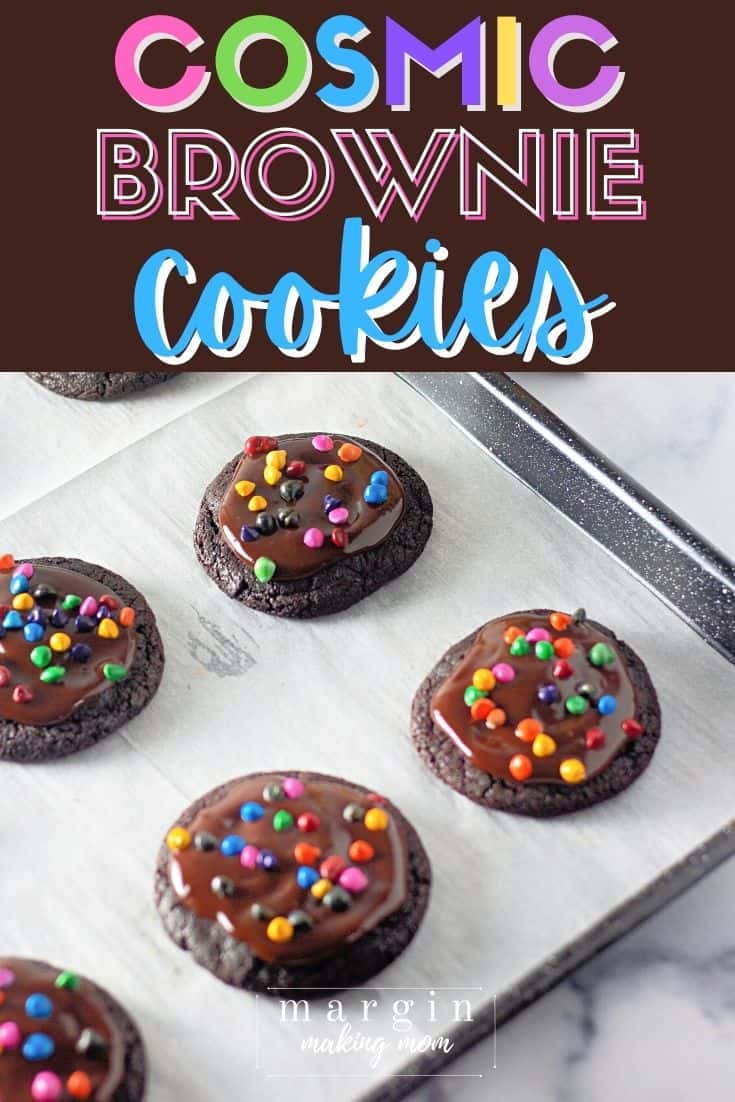 cosmic brownie cookies on a lined baking sheet