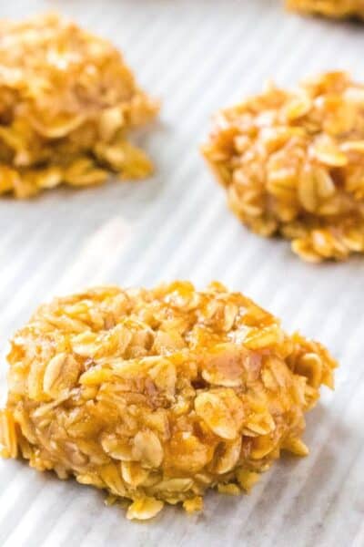 no bake pumpkin oatmeal cookies on a wax-paper lined surface