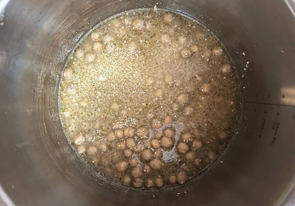 liquid and seasonings added to quinoa and chickpeas in the Instant Pot, prior to cooking.