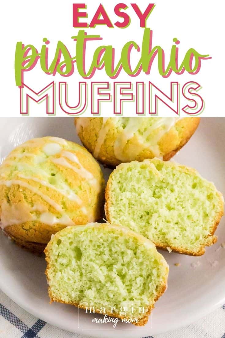 pistachio muffins on a white plate, with one muffin cut in half to show the moist interior