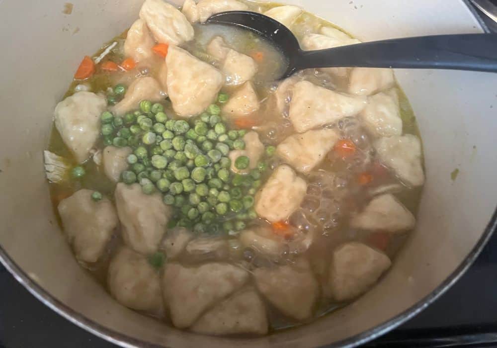 frozen peas added to simmering broth