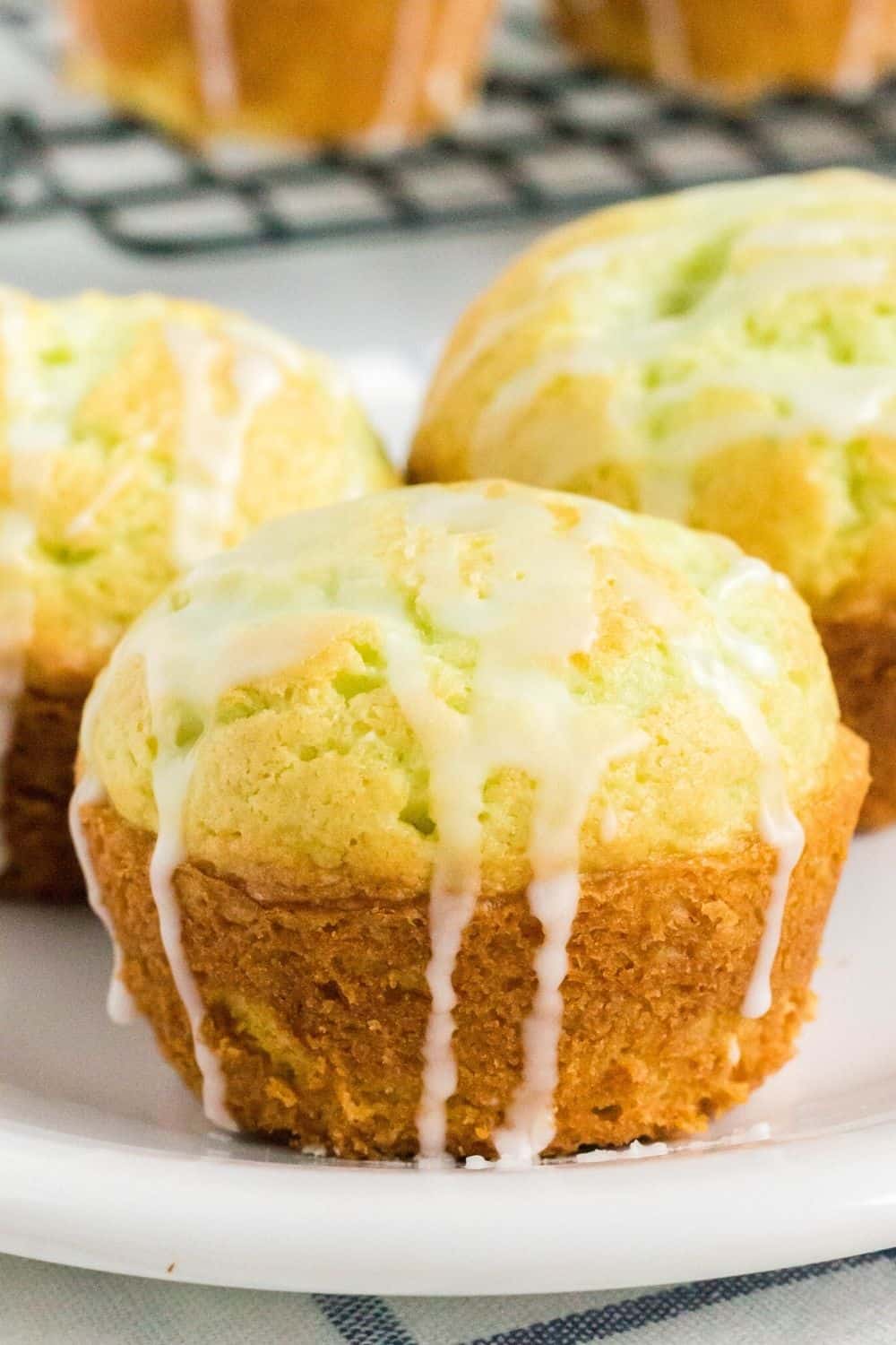 close-up view of a homemade pistachio muffin drizzled with glaze
