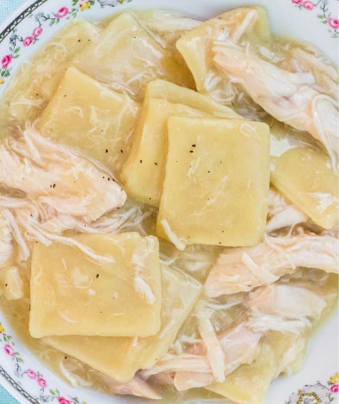 close-up of chicken and dumplings made with frozen dumplings served in a white floral china bowl