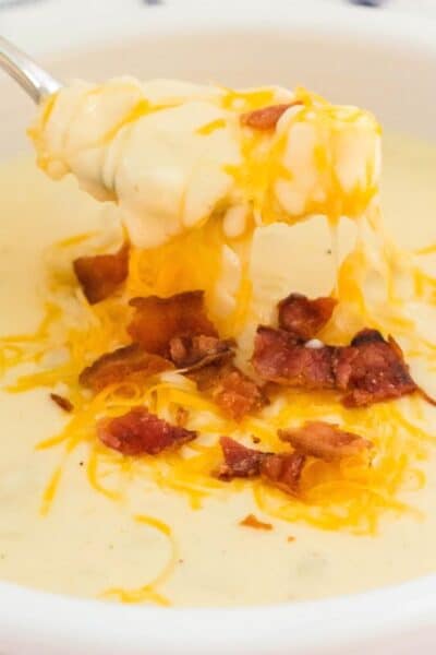 hash brown potato soup with melted shredded cheese and crumbled bacon on top.