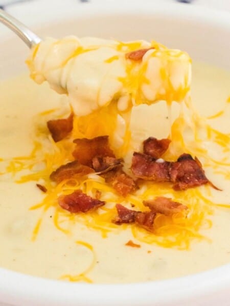 hash brown potato soup with melted shredded cheese and crumbled bacon on top.