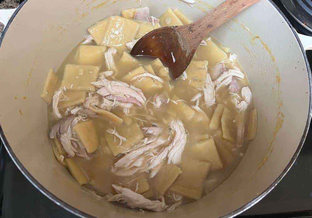 shredded cooked chicken added to the broth and dumplings mixture