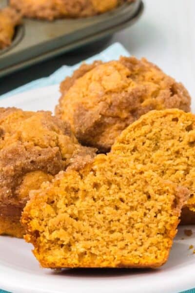 close-up view of sweet potato Bisquick muffins that have been cut in half, showing the moist interior and streusel topping