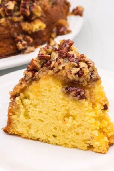 close-up view of a slice of pecan upside down cake, showing the tender interior and the caramelized pecan topping