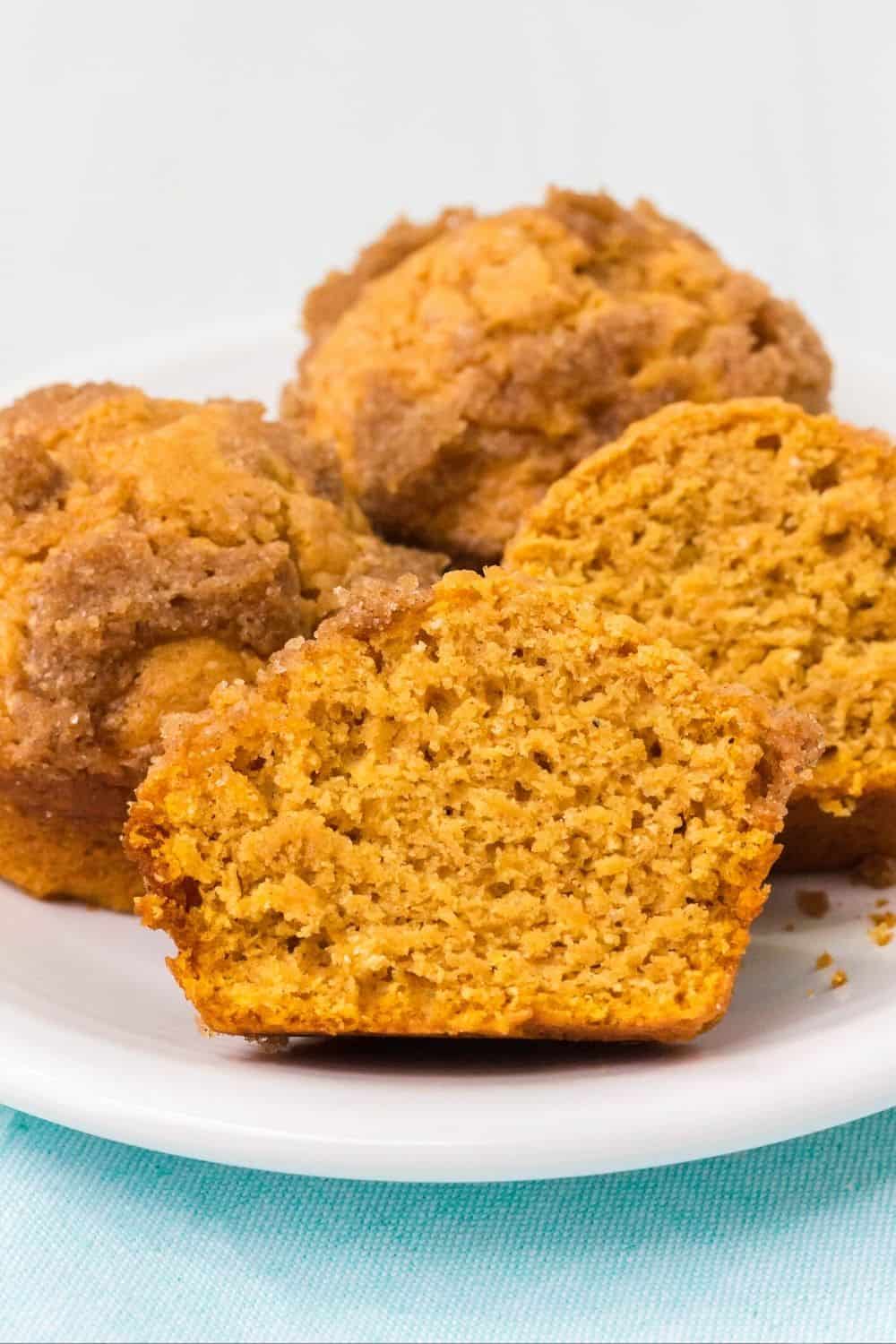 detailed view of a sweet potato muffin made with Bisquick, cut in half to show both the crunchy streusel topping as well as the tender interior.