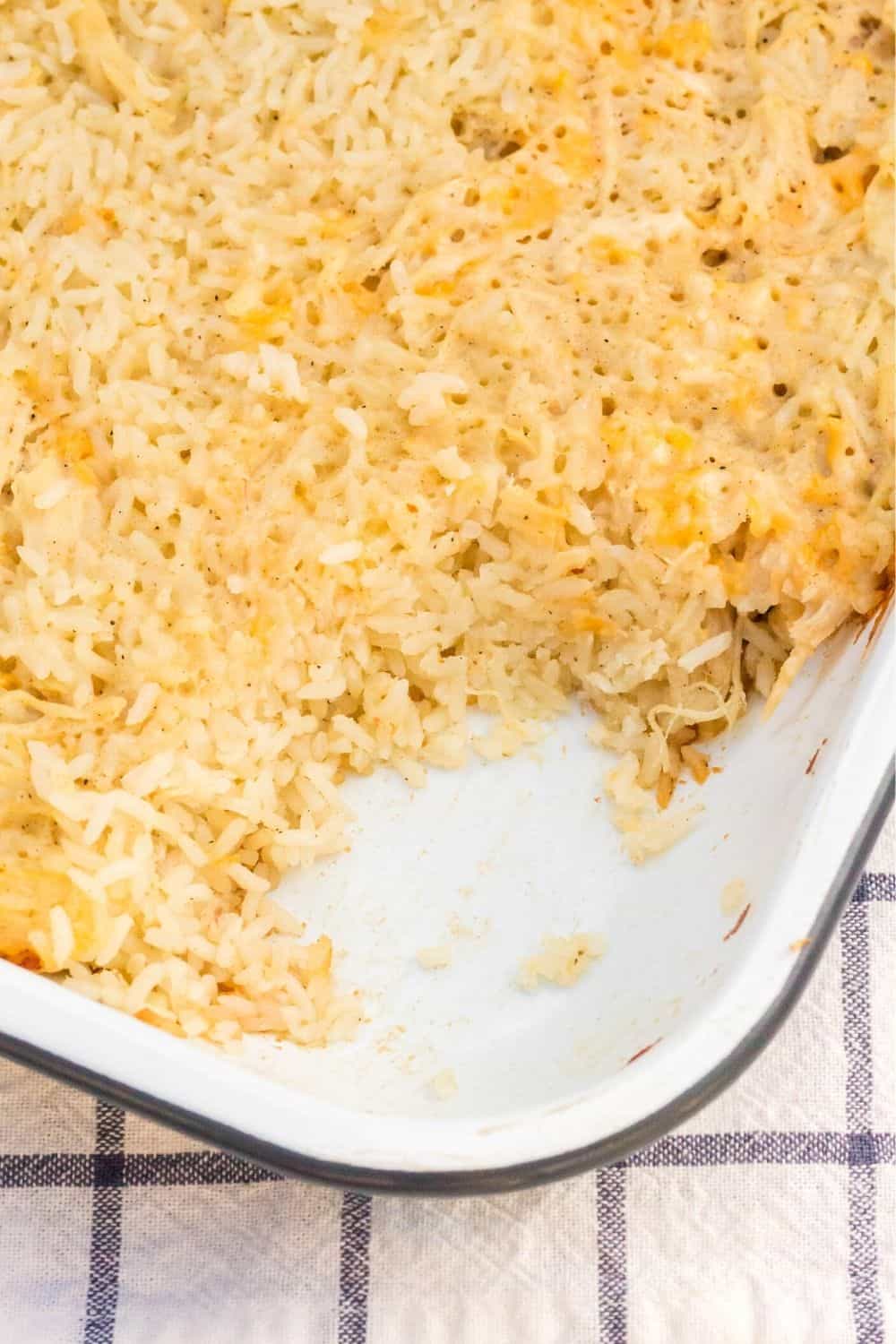 chicken and rice in a baking dish, with some of it scooped out