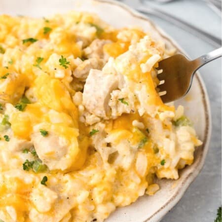 a fork lifts out a bite of chicken and rice with cream of chicken soup