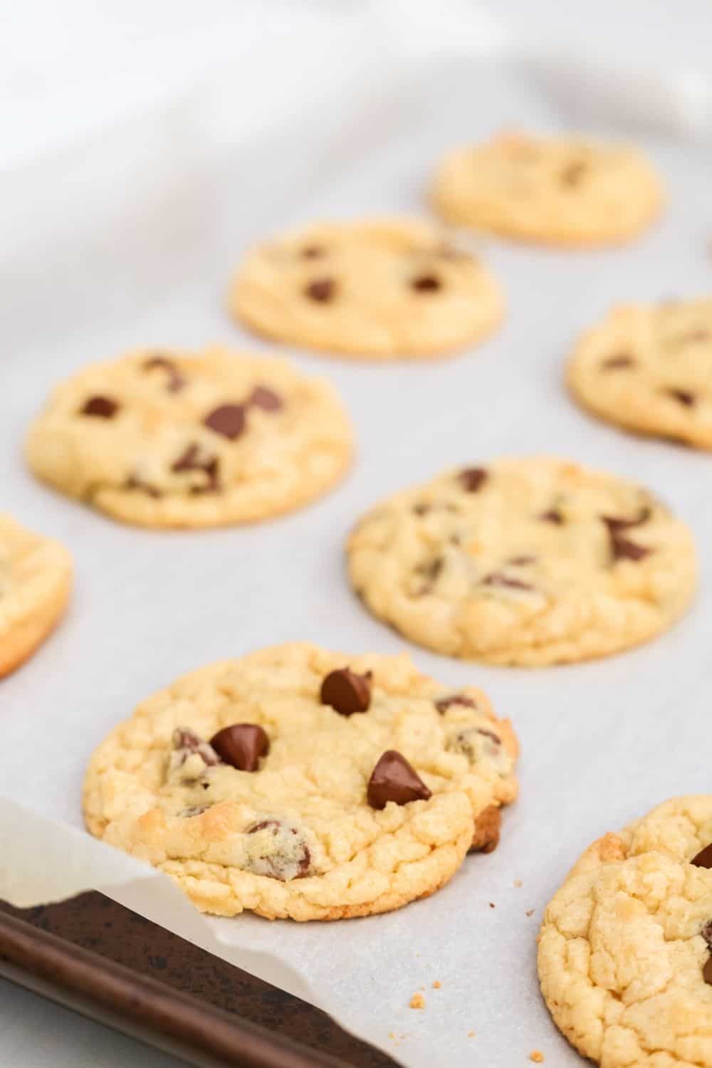 close-up view of freshly baked Bisquick chocolate chip cookies on a baking sheet