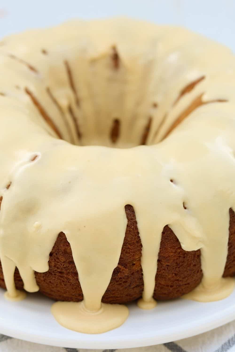 close-up view of the brown sugar caramel icing drizzled over the pear cake.