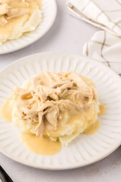 stove top chicken and gravy served over mashed potatoes on a white plate