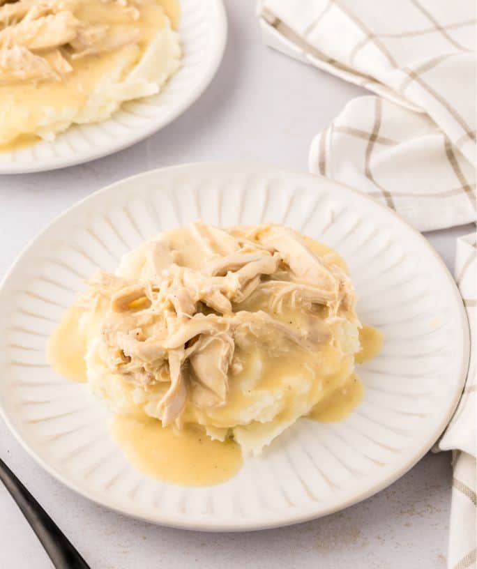 stove top chicken and gravy served over mashed potatoes on a white plate