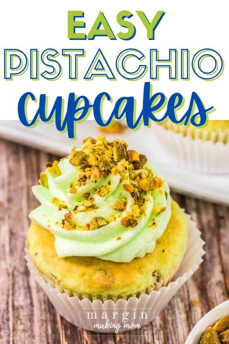 close-up view of a pistachio cupcake, topped with pistachio frosting and garnished with chopped pistachio nuts.
