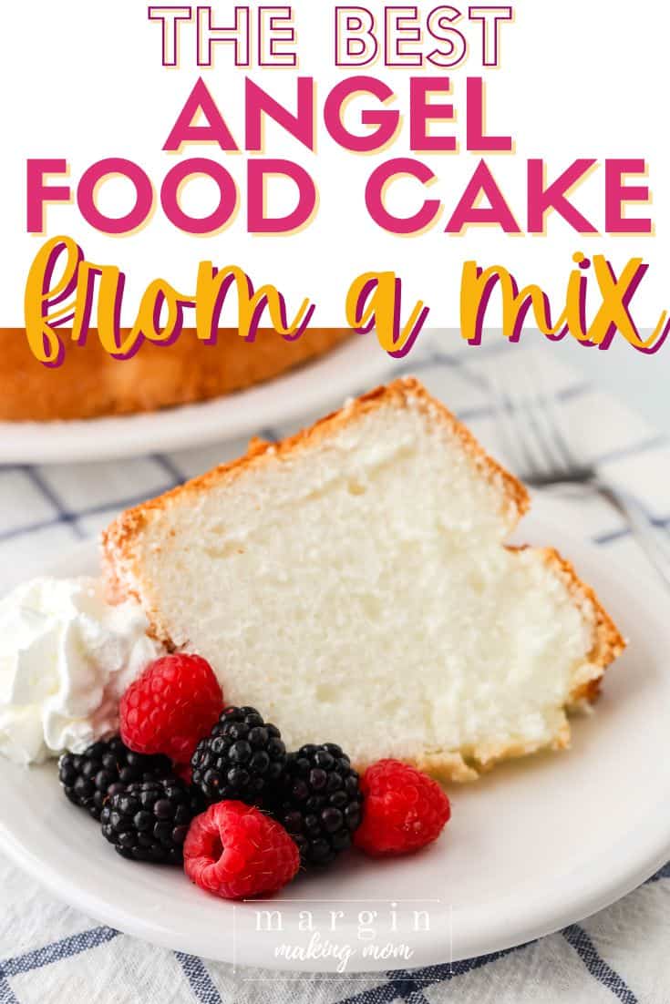 slice of angel food cake from a mix, served on a white plate with fresh berries and whipped cream.