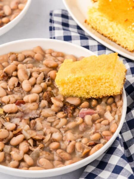 white bowl filled with southern style pinto beans and cornbread