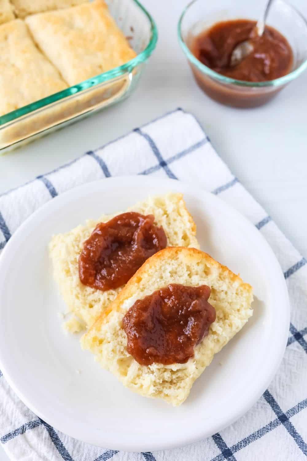 7-Up Biscuits made with Bisquick and topped with apple butter, served on a white plate